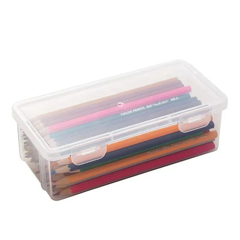 Transparent plastic storage box containing coloured pencils and drawing materials