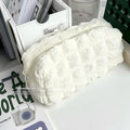 Beige and black fabric pencil case made from polyester for organising stationery.