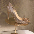 Women's gold pointed toe stiletto heels with sequin cloth upper and rhinestone decoration