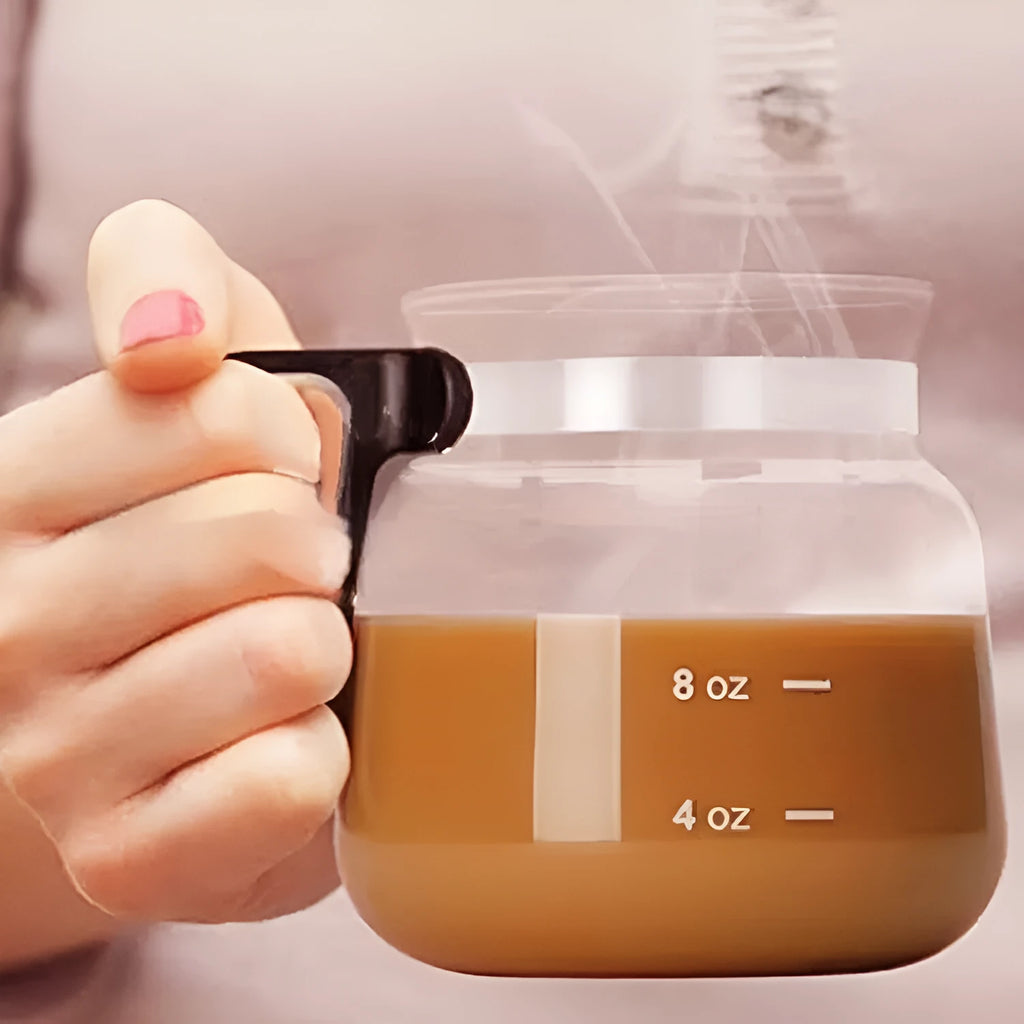Transparent borosilicate glass French press coffee maker with stainless steel plunger and a black silicone cover.