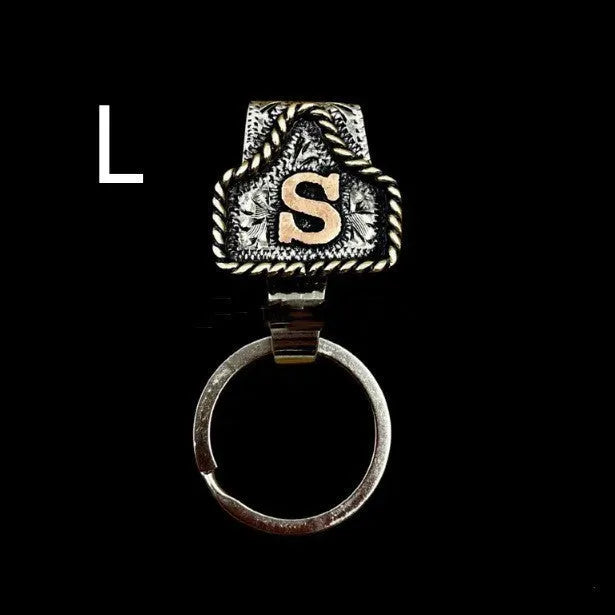 Handmade metal keychain featuring a cow tag on a belt loop design, shown in one of 26 available colours.