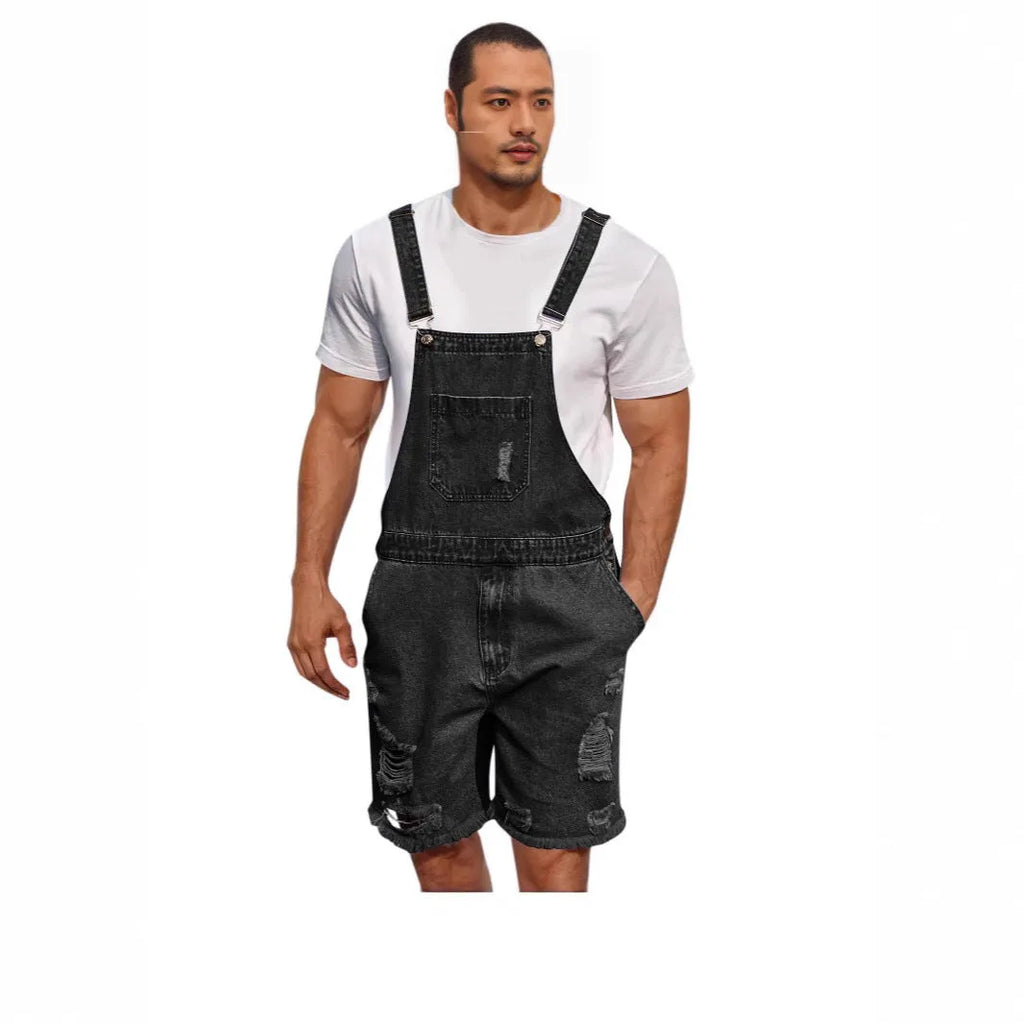 Men's ripped blue denim shorts with attached suspenders on a mid waist straight-leg fit.