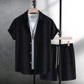 Men's black jacquard patterned short sleeve shirt and matching casual shorts laid flat.