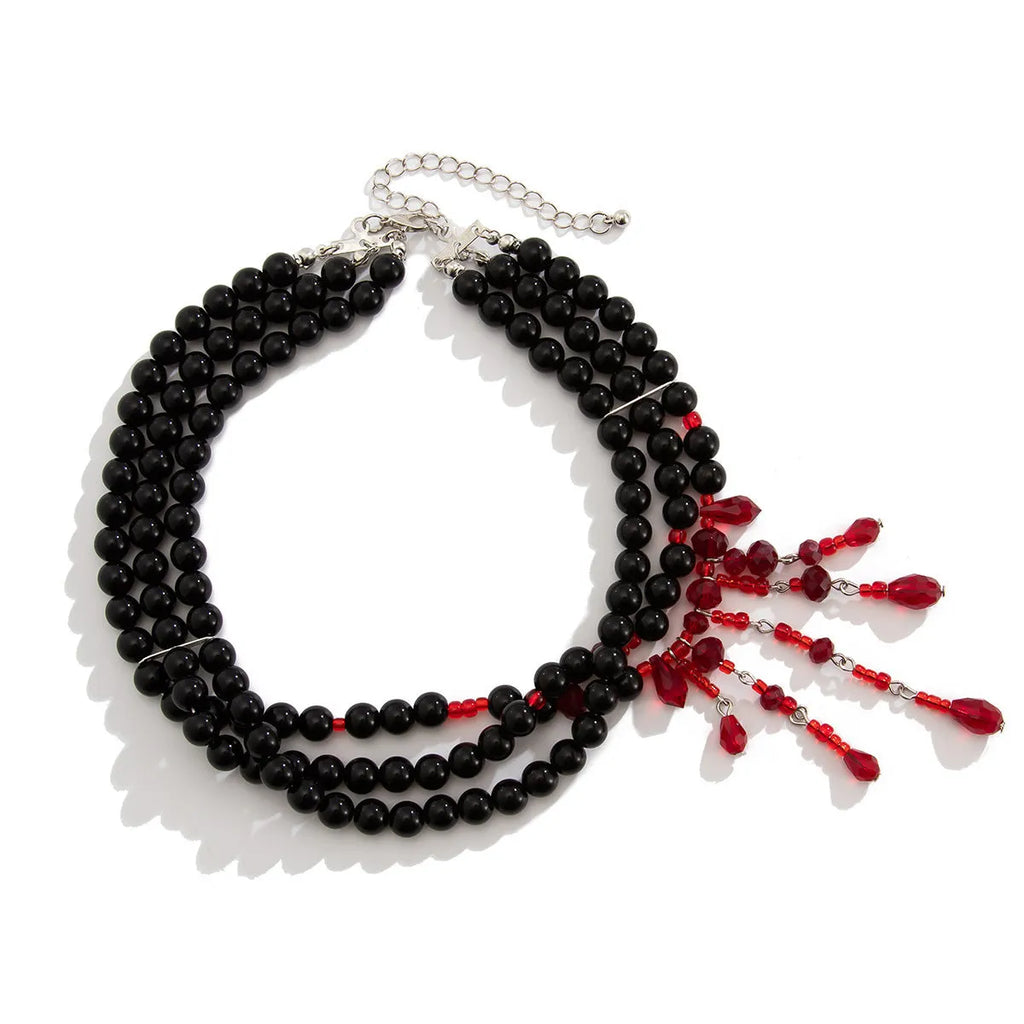 Men's Halloween necklace with red and black crystal blood drop pendant and pearl tassels on an adjustable chain