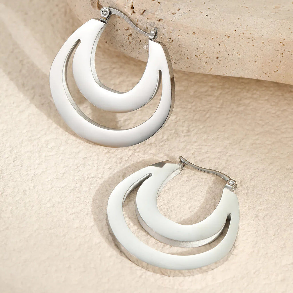 Geometric minimalist French earrings in gold and steel colours with round ring design elements