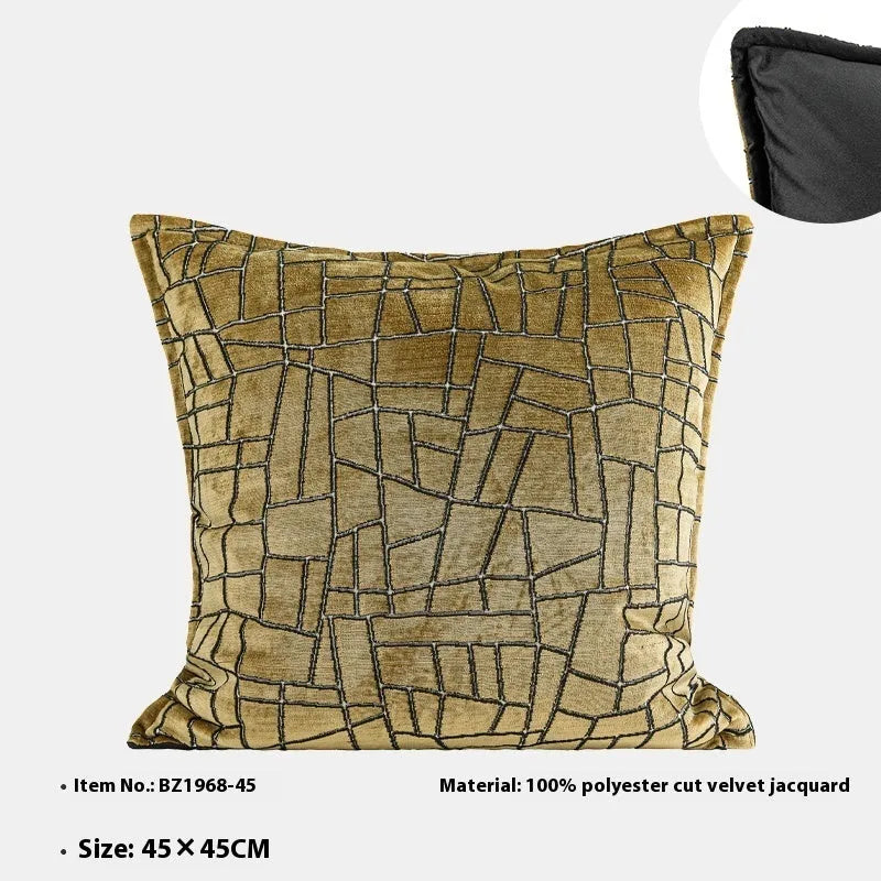 Gold geometric abstract pattern on a square polyester cushion cover and a lumbar pillow.