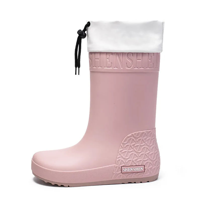 Solid-colour women's PVC rain boot with a non-slip sole in apricot, black, brown, or pink.