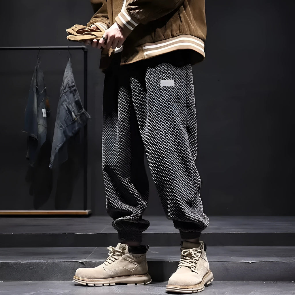 Men's grey straight-leg sweatpants with ankle ties on a hanger