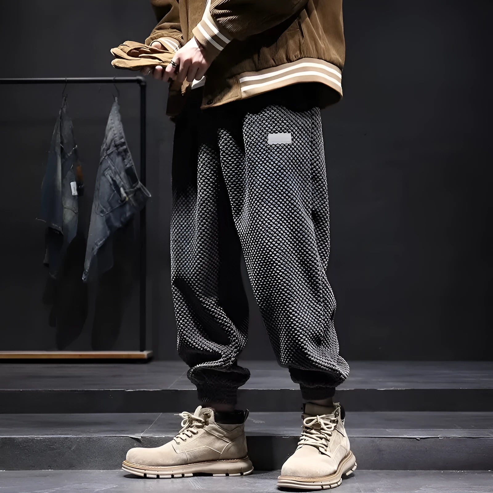 Men's grey straight-leg sweatpants with ankle ties on a hanger