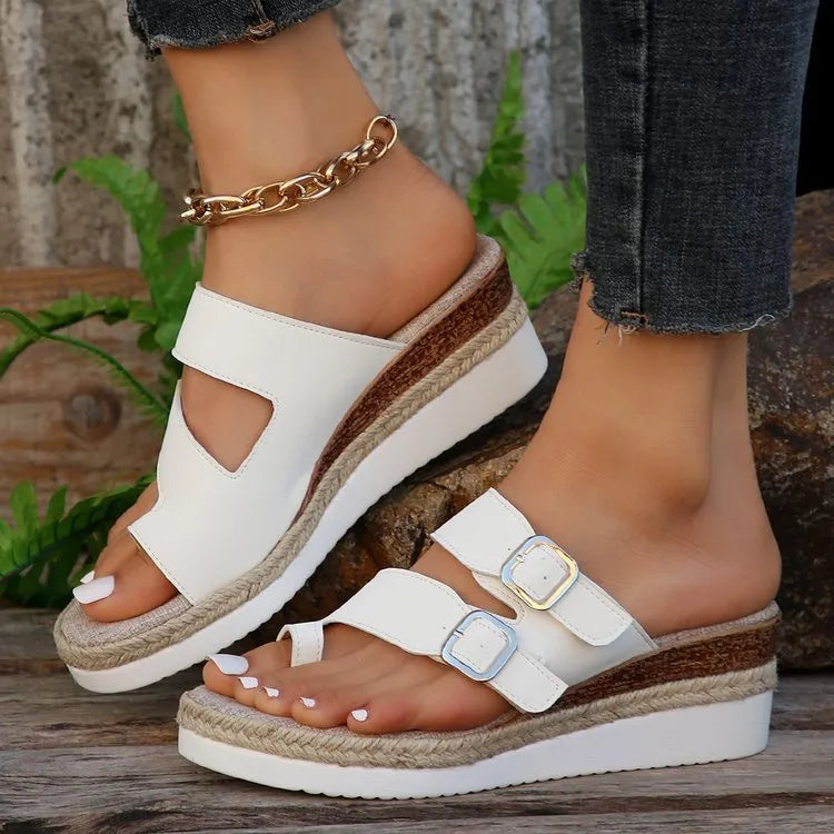 White women's woven patent leather wedge sandals with finger-fit design and peep toe.