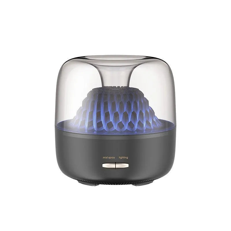 Round resin aroma diffuser in beige on a desk, with mist rising from single outlet, plug-in cord visible