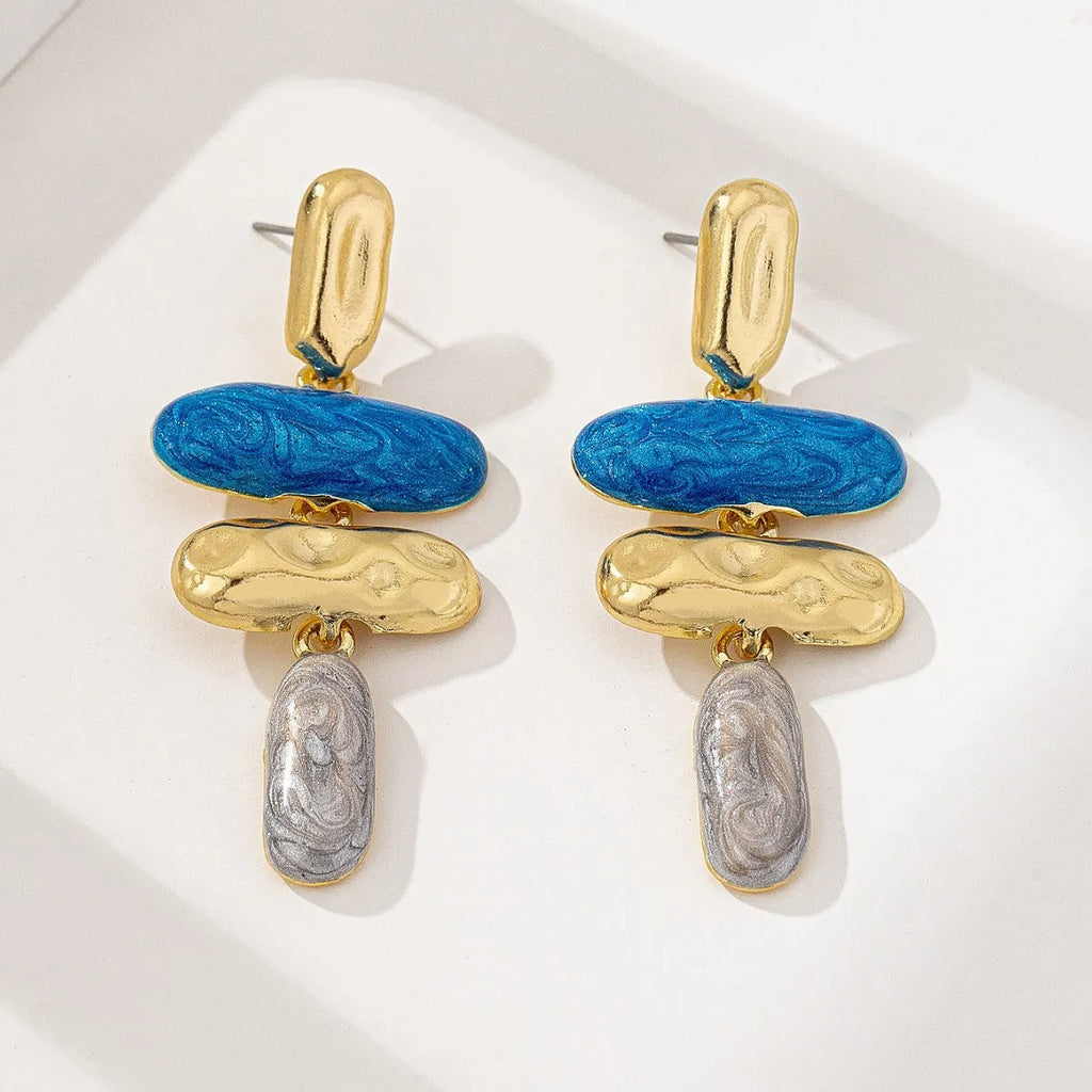 Gold-electroplated zinc alloy geometric stud earrings on a plain background.