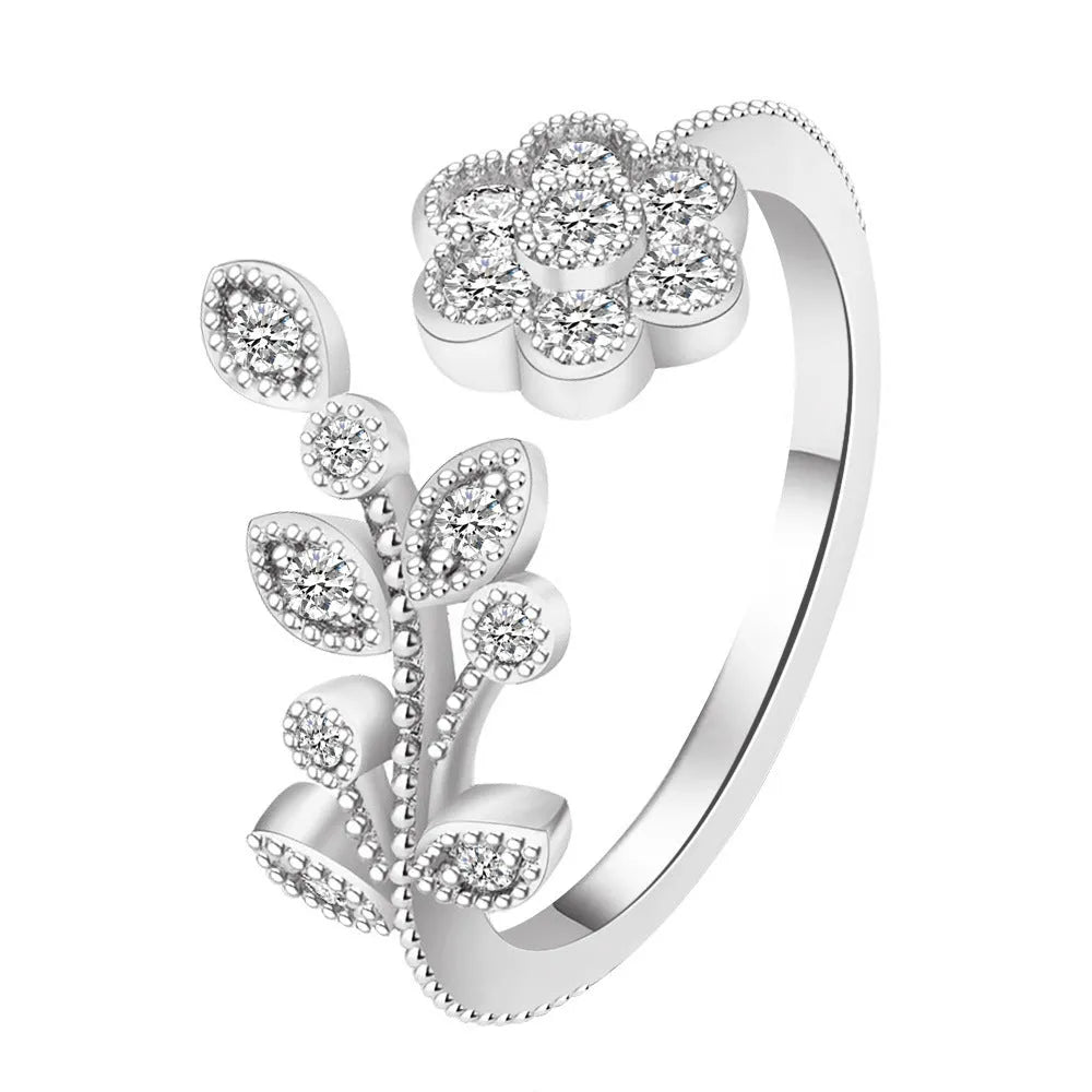 Women's open ring with flower and leaf design on a copper base with a diamond finish.