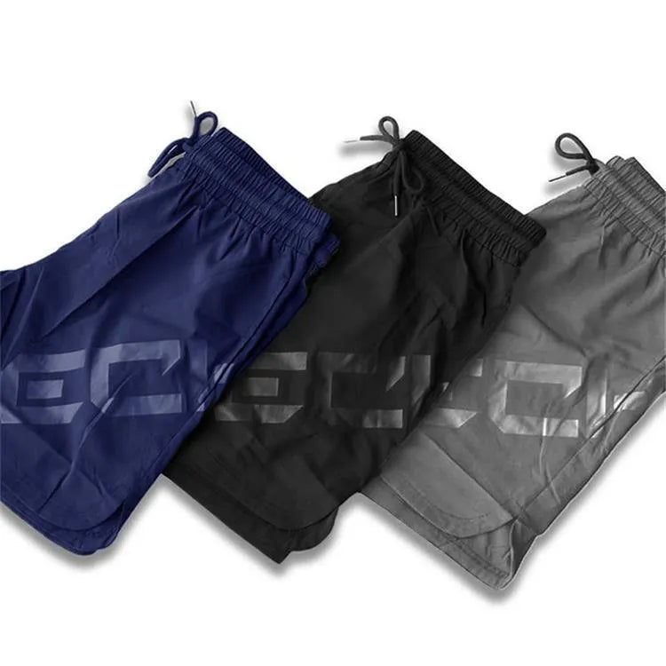 Men's black knee-length quick-dry nylon running shorts laid flat, showing mid-waist and sport design.