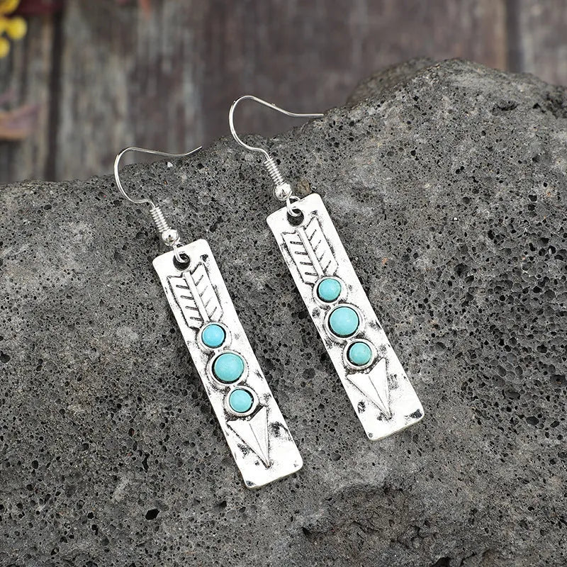 Long silver geometric earrings with turquoise inlay details on zinc alloy