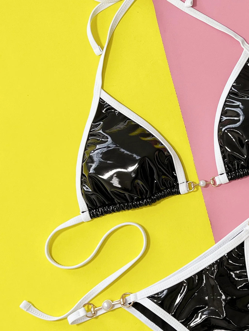 Solid black women's two-piece bikini swimsuit set on a hanger.