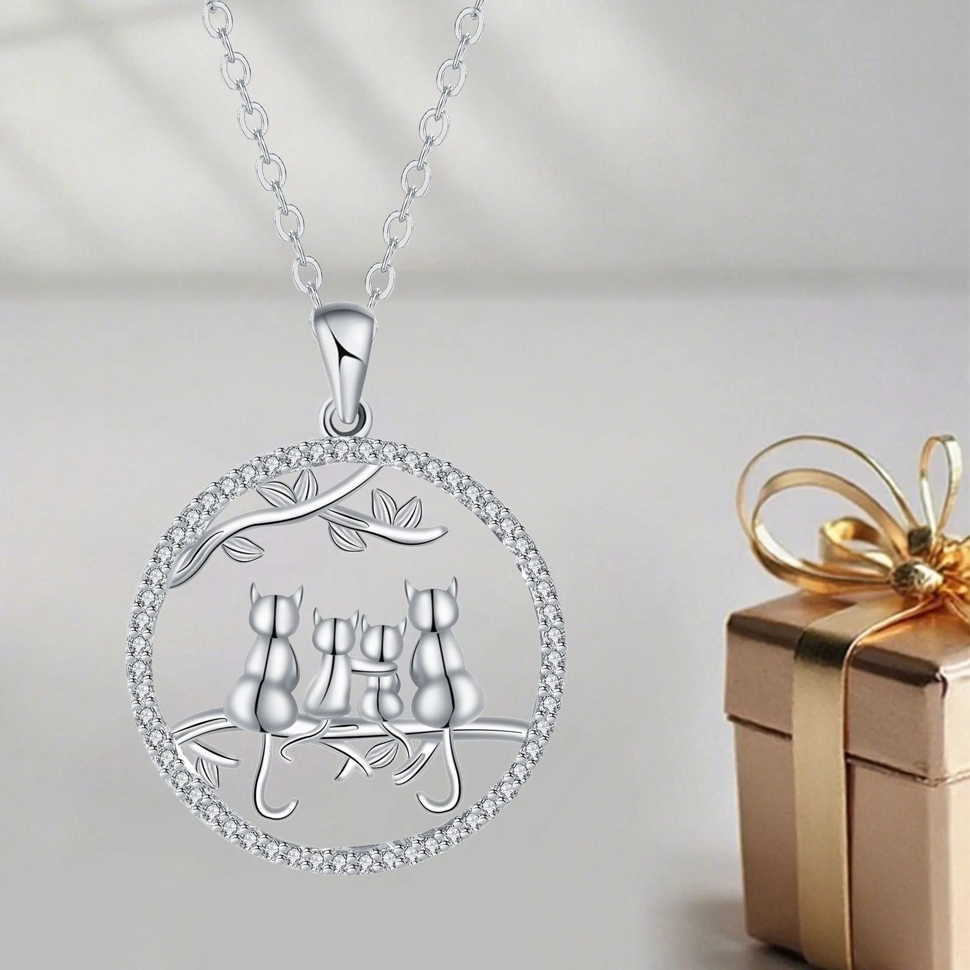 Copper necklace with a cat pendant on a cross chain, electroplated finish.