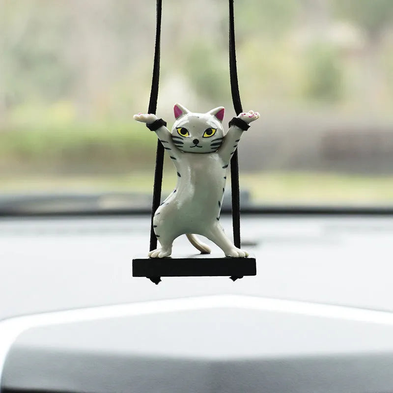 Resin cartoon cat pendant for car interior decoration on a rope, shown in multiple colour options.