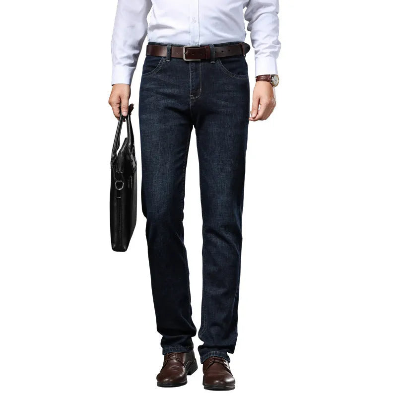 Man wearing loose fit straight-leg stretch jeans in blue denim for a business casual look.