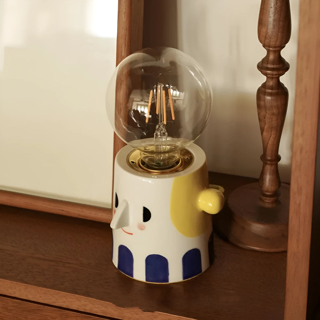 Handmade ceramic lamp with ball headlight design on bedside table