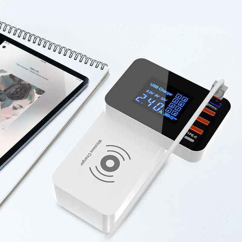 White multi-port USB and wireless fast charger with international plug adapters on a desk