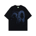 Men's loose-fit grey cotton T-shirt featuring a retro graphic character print on the chest.