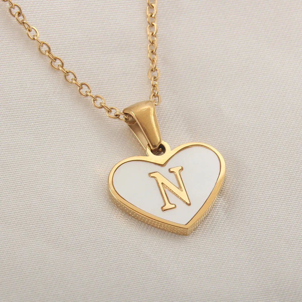 Gold plated heart necklace with white shell detail on an adjustable chain