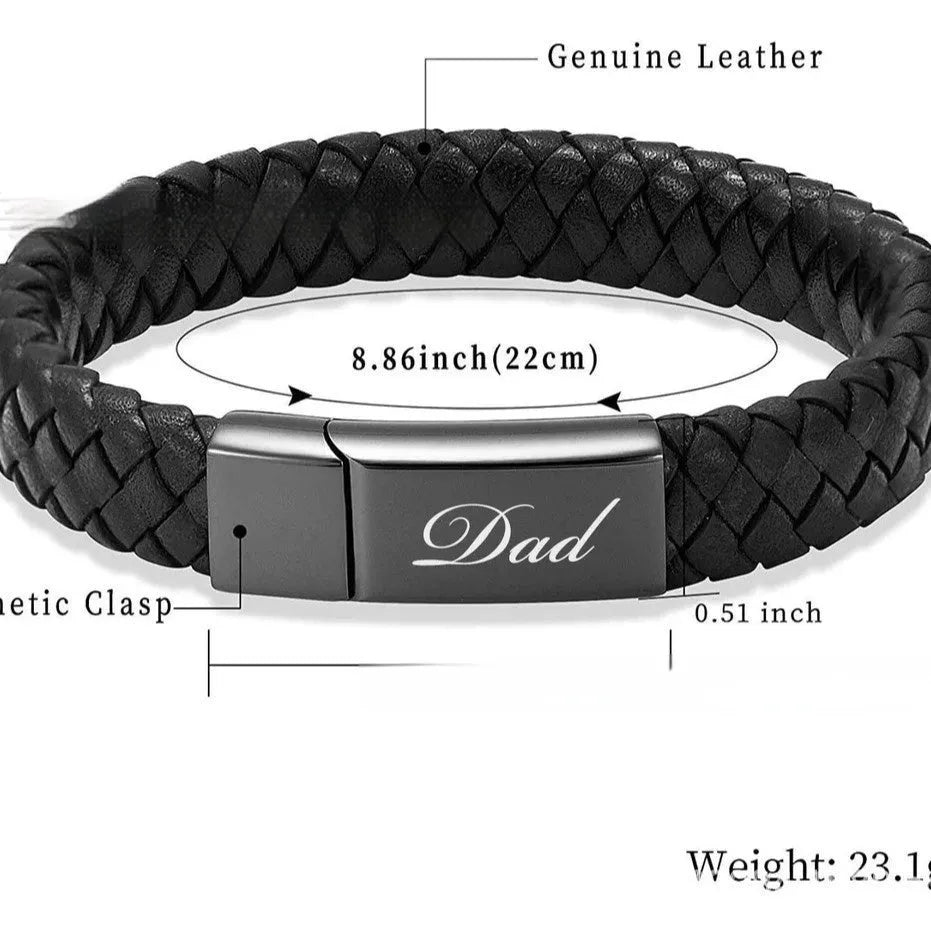 Black leather and stainless steel casket bracelet with engraved text on a gift box.