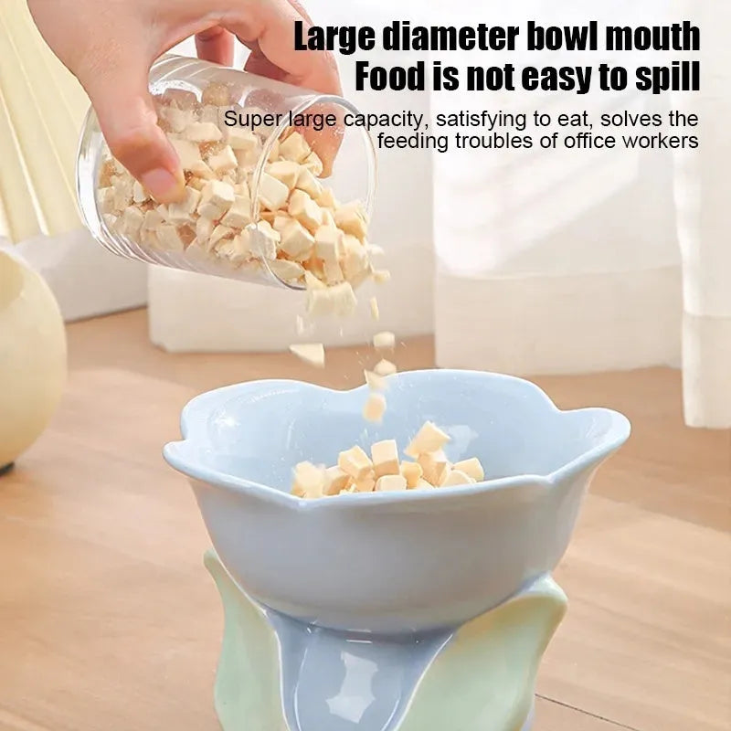 Blue ceramic raised pet bowl with floral pattern and non-slip base for cats or small dogs.