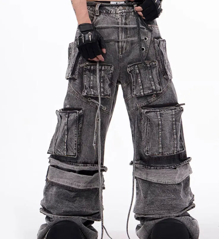 Grey denim distressed overalls with rope stitching and a wide-leg mop pants silhouette.