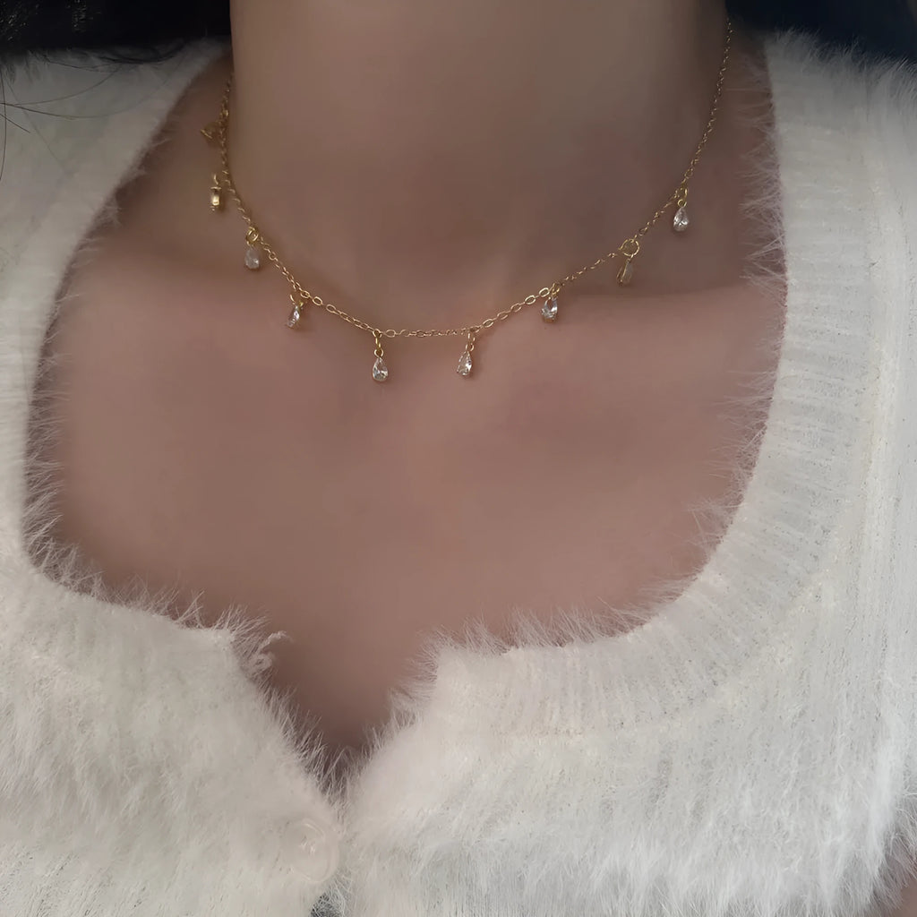 Zircon jewellery set showing necklace, earrings and anklet with geometric meteor shower design