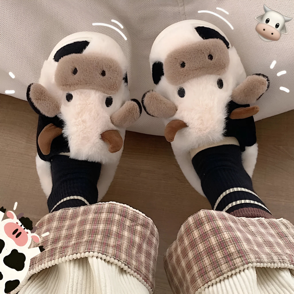 White cow print faux fur plush slippers for women with a non-slip textured sole.