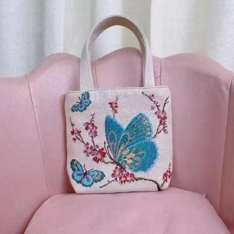 Canvas embroidery handbag with gold wire detail shown in an artistic colour design.