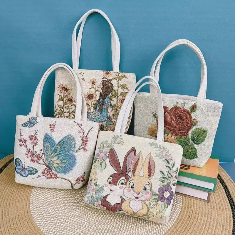 Canvas embroidery handbag with gold wire detail shown in an artistic colour design.