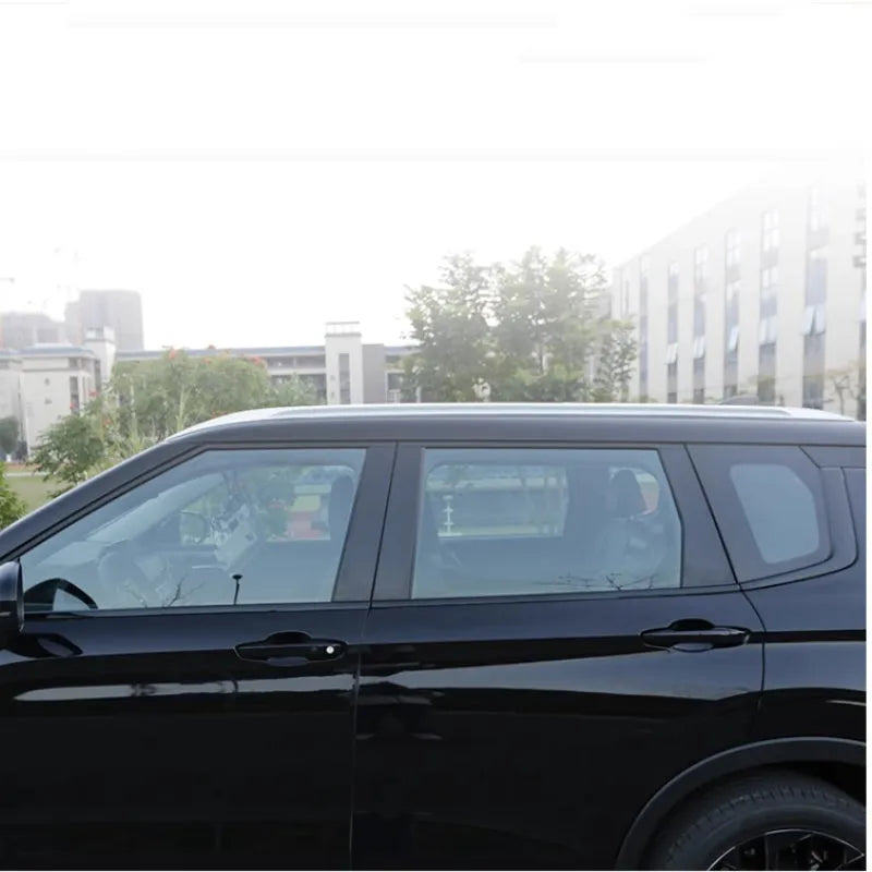 Mitsubishi Outlander car with black protective vinyl film applied to its exterior door and window pillars.