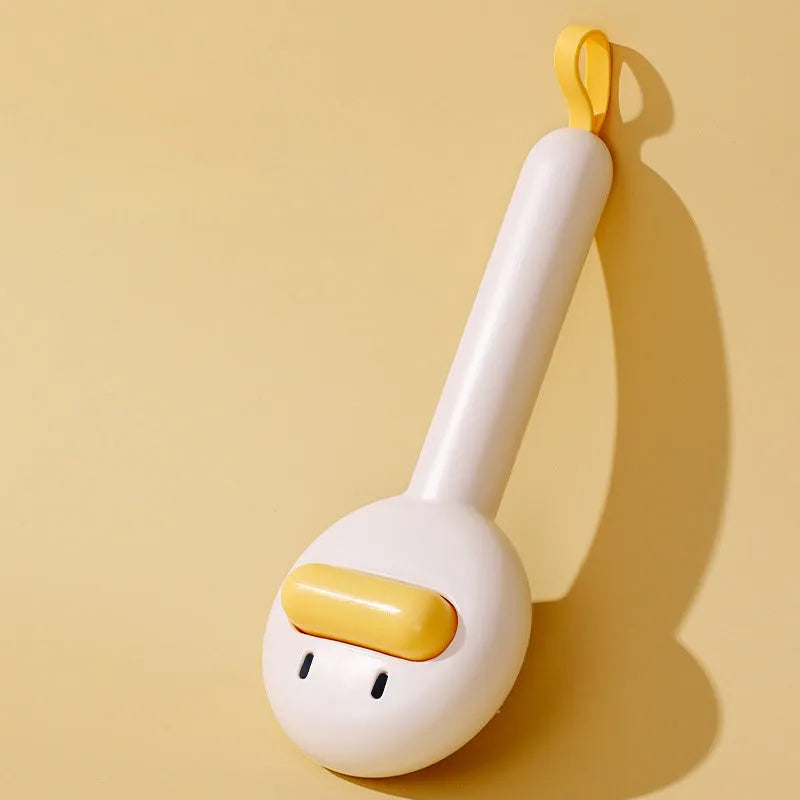 Small yellow duck-shaped pet comb with needle bristles for cat and dog grooming