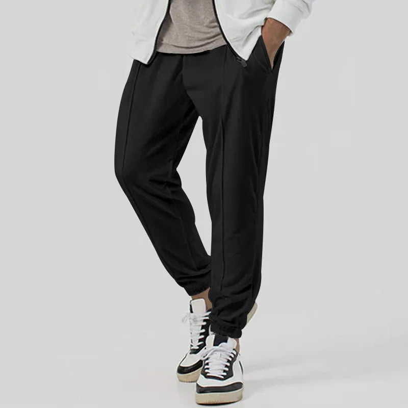 Men's grey straight-leg casual track sweatpants made from cotton blend fabric on a neutral background.