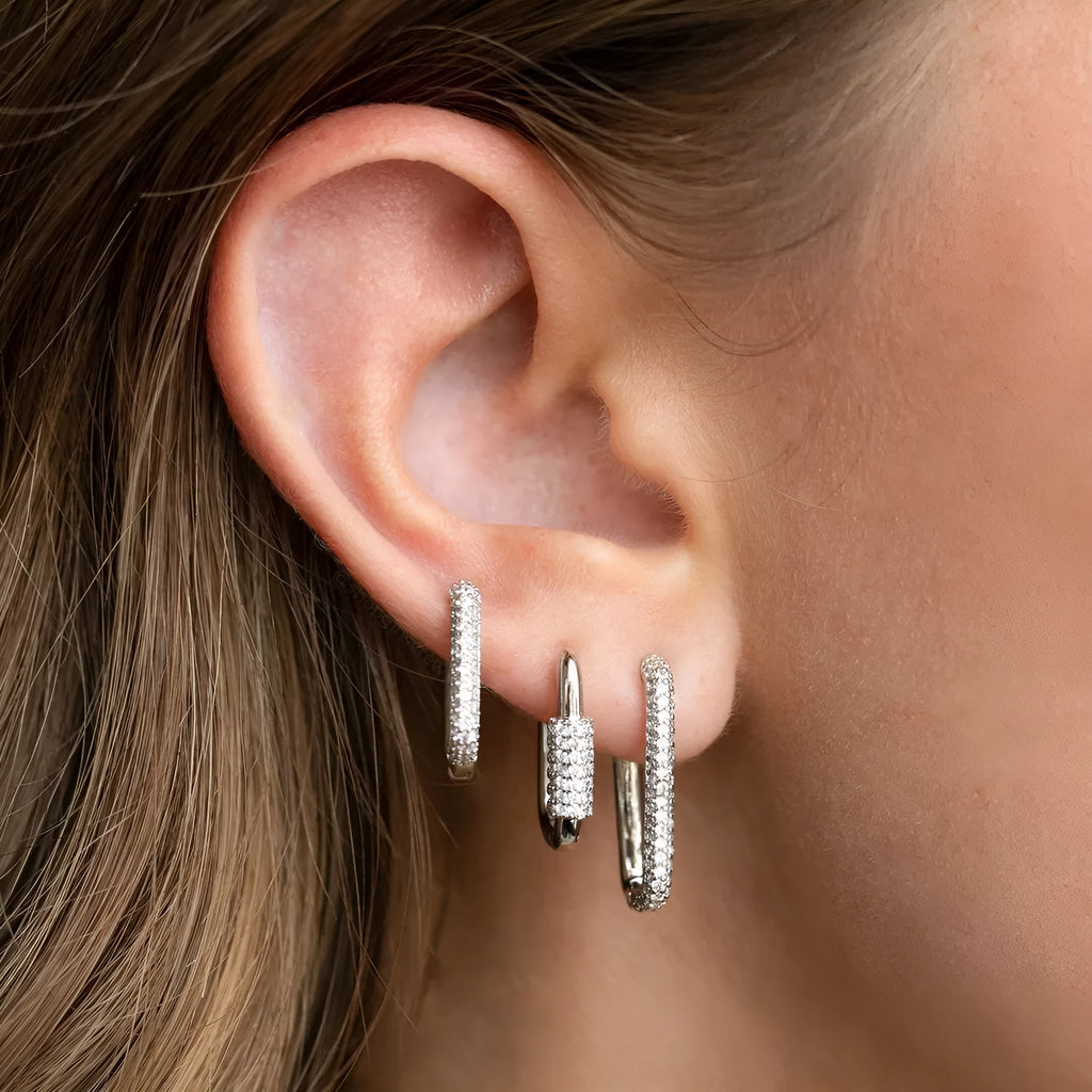 Three geometric copper ear clips with micro inlaid zircon detailing in gold and white finishes