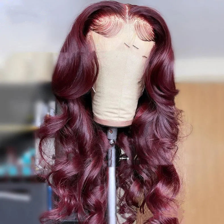 Front lace synthetic wig in wine red long curly style with long bangs on a mannequin head