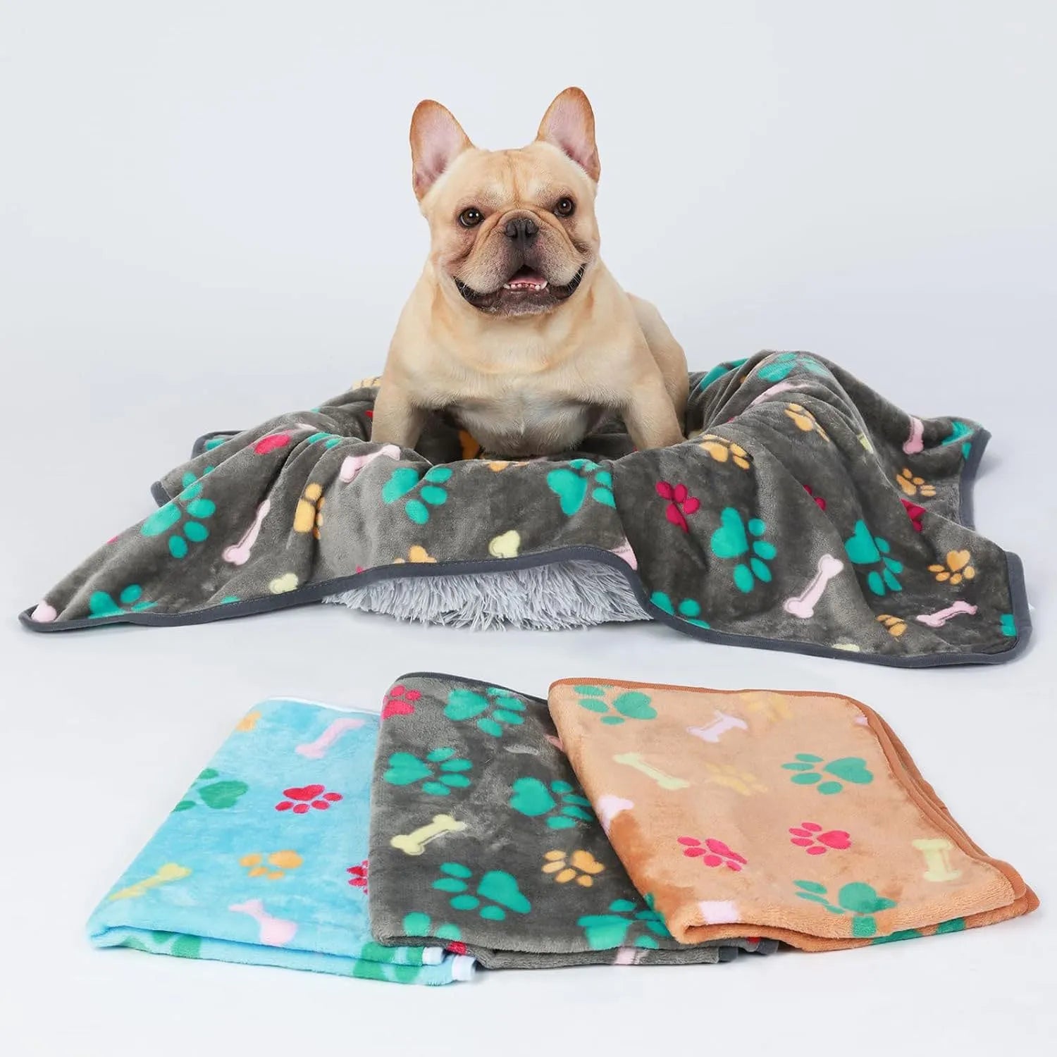 Soft cloth pet blanket with confetti bone and paw print pattern in beige colour on a light background
