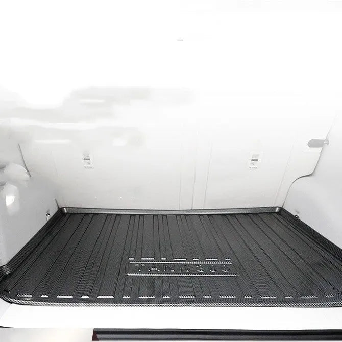 Black car boot liner with carbon fibre pattern, designed for a model-specific TPE tail pad fit.