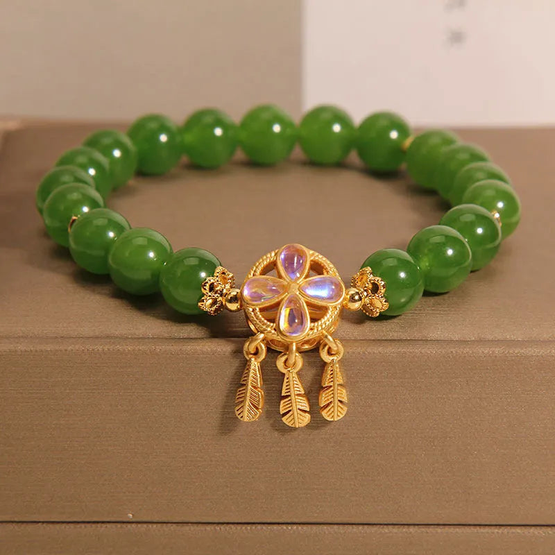 Green jasper bracelet for women with a four-leaf clover dream catcher crystal pendant on a chain.