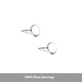 A pair of flat, round S999 sterling silver stud earrings on a plain background.