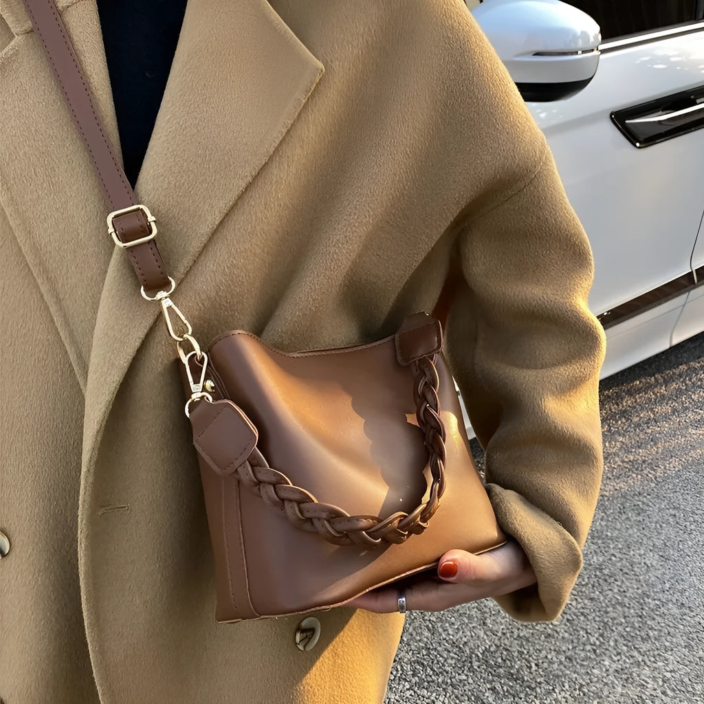 Retro woven PU leather crossbody bucket bag in khaki colour showing adjustable strap and bucket shape