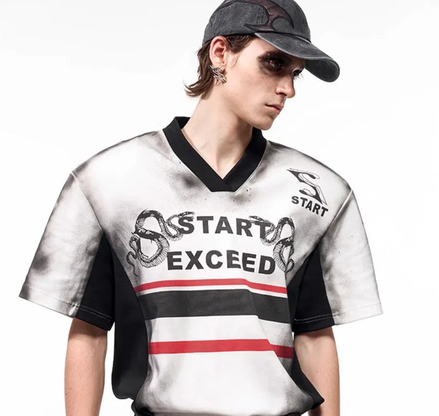 Women's V-neck short-sleeved top with a grey letter snake pattern print and padded shoulders.