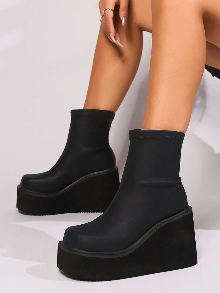 Black plus size women's boots with wedge heel and waterproof platform in short and high shaft styles