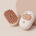 White and yellow rechargeable pet steam brush with rubber comb teeth and water tank.