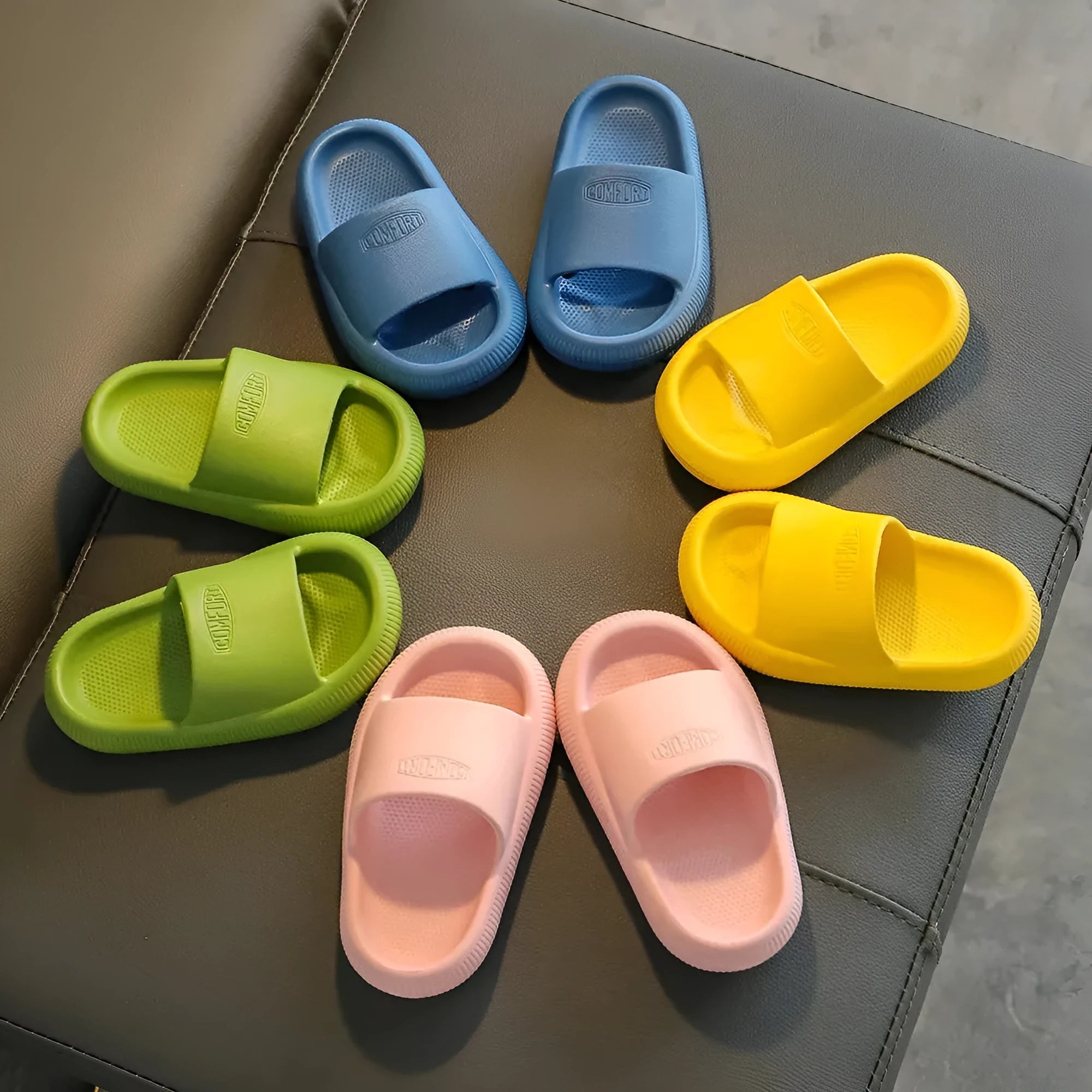 Children's EVA literal slippers with injection moulded soles in mixed colours showing non-slip wear-resistant design