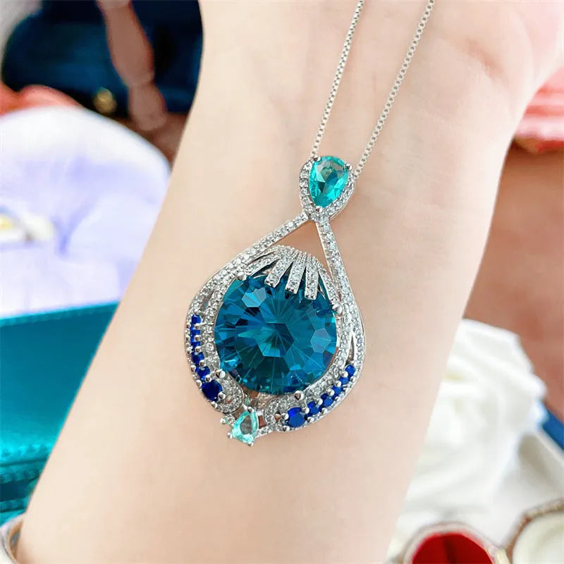 Blue geometric pendant necklace with fireworks cut crystal gems on water wave chain