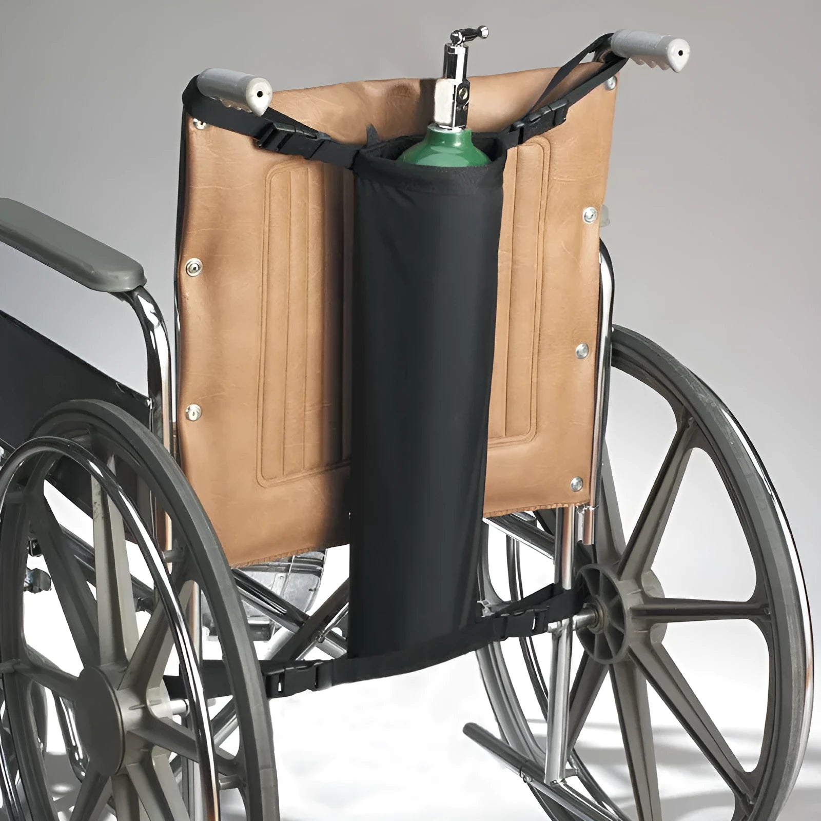 Black cylindrical pannier bag for an oxygen cylinder attached to a wheelchair.